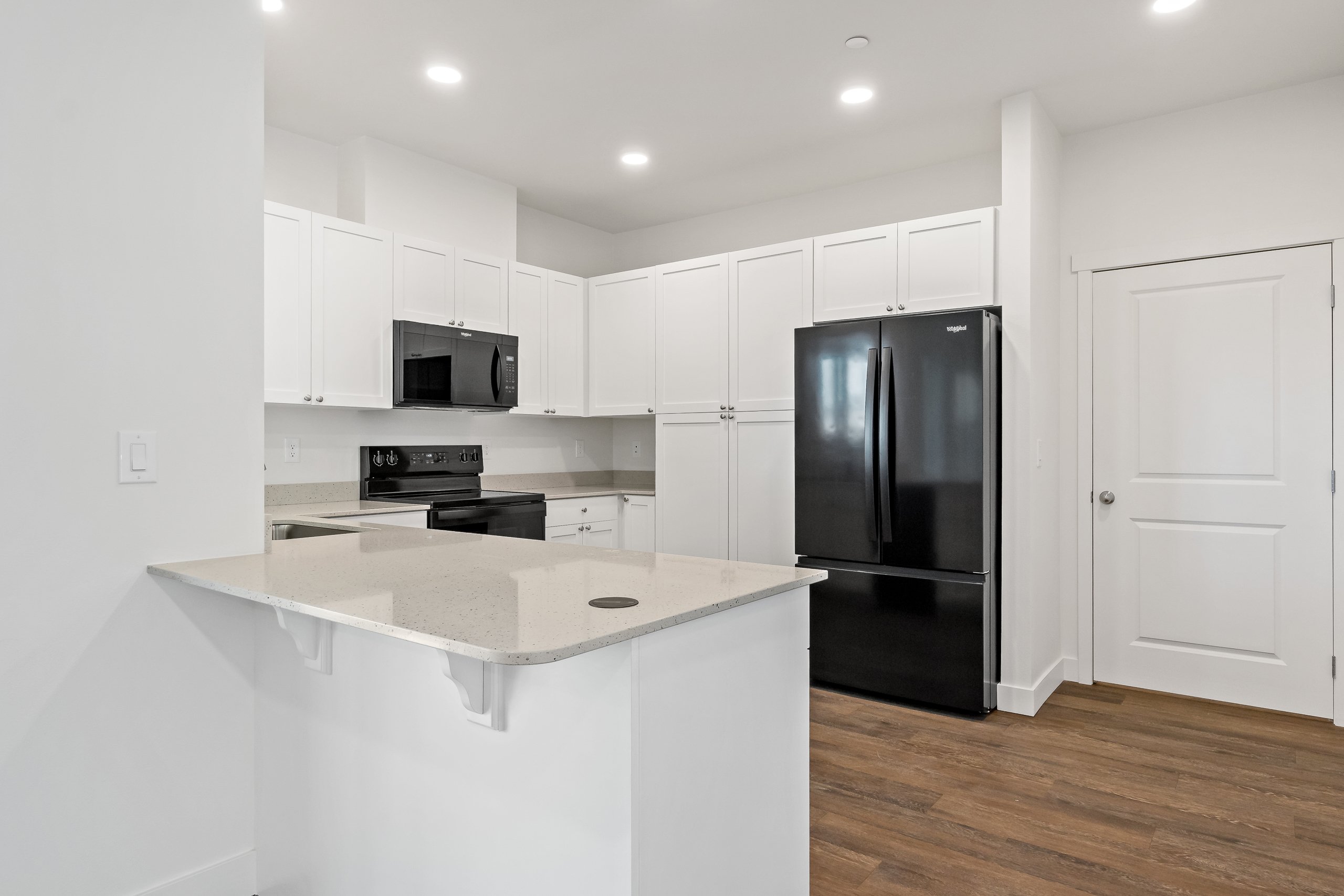 Kitchen with Quartz Countertops and Black Appliances