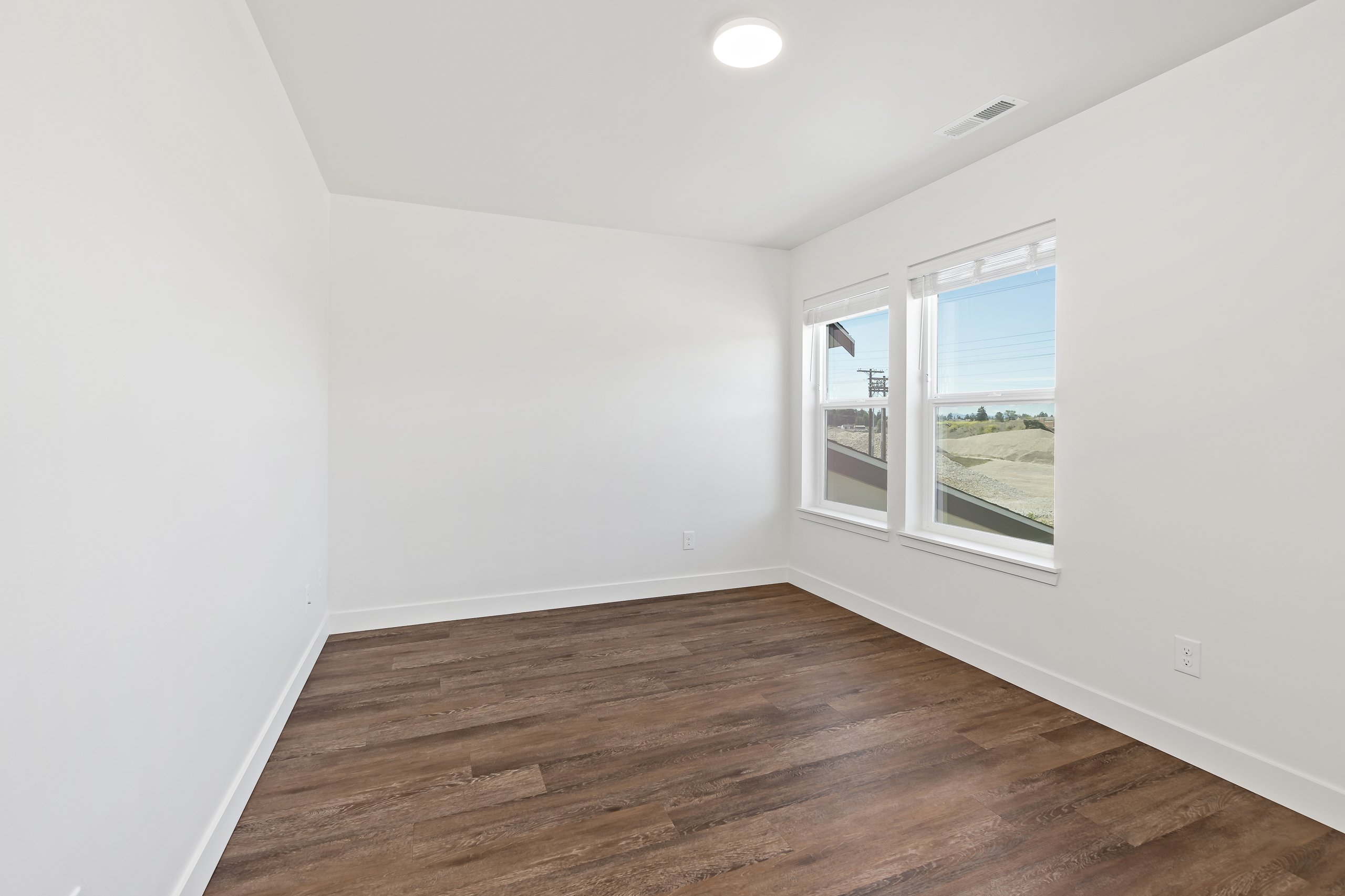 Bedroom with Oversized Windows and LVP Flooring